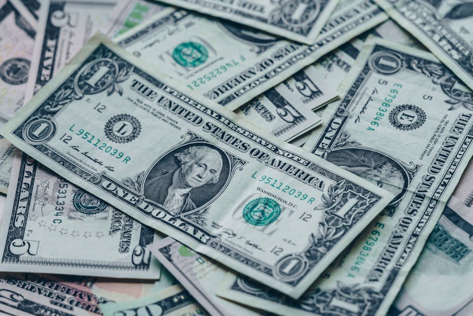 Close-up image of stacked US dollar bills representing wealth and finance.