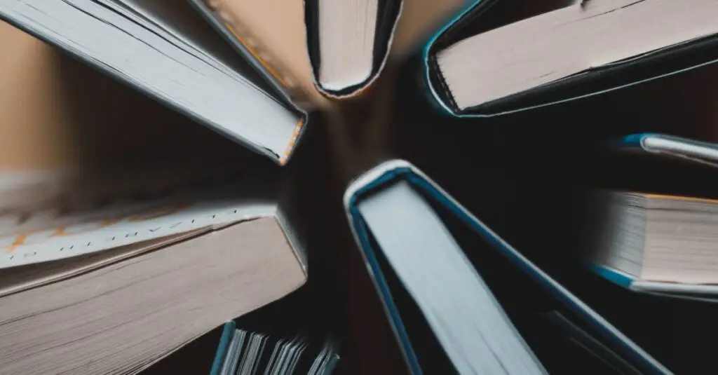 Top-down view of open books arranged in a circle showing spines and pages.